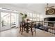 Bright dining area with a view to the deck and living room featuring modern decor and abundant natural light at 25362 E Indore Dr, Aurora, CO 80016