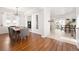 An elegant dining room with hardwood floors, a modern light fixture, and views into the backyard at 25362 E Indore Dr, Aurora, CO 80016