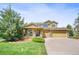 Inviting two-story home featuring a covered porch, well-manicured lawn, and three-car garage at 25362 E Indore Dr, Aurora, CO 80016