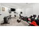 Well-equipped home gym featuring various cardio and strength training machines at 25362 E Indore Dr, Aurora, CO 80016
