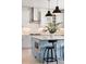 Stylish kitchen with modern appliances, a blue island with seating, and sleek pendant lighting at 25362 E Indore Dr, Aurora, CO 80016