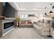 Relaxing living room with electric fireplace, plush seating, and wall-mounted TV at 25362 E Indore Dr, Aurora, CO 80016