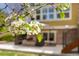 Outdoor patio with furniture visible through blooming tree branches at 25362 E Indore Dr, Aurora, CO 80016