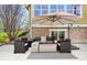 Inviting outdoor patio with fire pit, seating, and shade umbrella at 25362 E Indore Dr, Aurora, CO 80016