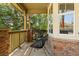 Charming outdoor seating area on a covered porch with stone pillars and views of the green landscape at 25362 E Indore Dr, Aurora, CO 80016