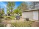 Large backyard featuring picnic table, fire pit, and storage shed at 113 E Saint Clair Ave, Longmont, CO 80504