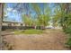 Spacious backyard featuring a large grassy area, mature trees, and storage shed at 113 E Saint Clair Ave, Longmont, CO 80504