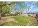 Large backyard featuring grass, fire pit, picnic table, and storage shed at 113 E Saint Clair Ave, Longmont, CO 80504
