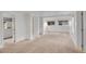 Bedroom with neutral carpet, closet with shelving, and windows for natural light at 113 E Saint Clair Ave, Longmont, CO 80504