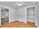 Bedroom with wood floors, a closet with shelving, and view to living area at 113 E Saint Clair Ave, Longmont, CO 80504