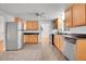 Spacious kitchen with stainless steel appliances, wood cabinets, and tile floor at 113 E Saint Clair Ave, Longmont, CO 80504