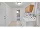 Bright laundry room with tile floor, overhead cabinets, and a view to the bathroom at 113 E Saint Clair Ave, Longmont, CO 80504