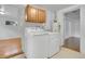 Bright laundry room with tile floor, overhead cabinets, and modern washer and dryer at 113 E Saint Clair Ave, Longmont, CO 80504