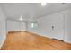 Bright living room features hardwood floors, a window, and a doorway, freshly painted at 113 E Saint Clair Ave, Longmont, CO 80504
