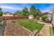 Expansive backyard with a well-manicured lawn, a wooden fence, a shed, and a patio area at 8475 W 74Th Dr, Arvada, CO 80005