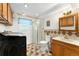 Functional bathroom featuring a walk-in shower, a modern washing machine, and a neutral color palette at 8475 W 74Th Dr, Arvada, CO 80005