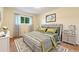Comfortable bedroom with a tufted headboard, plush bedding, and soft lighting at 8475 W 74Th Dr, Arvada, CO 80005