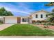 Charming two-story home with a well-manicured lawn and attached two-car garage at 8475 W 74Th Dr, Arvada, CO 80005