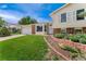 Well-manicured front yard, charming brick accents, and a cozy porch enhance this home's curb appeal at 8475 W 74Th Dr, Arvada, CO 80005