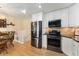 Open-concept kitchen featuring stainless steel appliances and an adjacent dining area at 8475 W 74Th Dr, Arvada, CO 80005