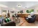 Spacious basement living room with wood paneling, carpeted floors, and a fireplace at 8475 W 74Th Dr, Arvada, CO 80005