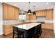 Gourmet kitchen with light wood cabinets, marble countertops, and high-end appliances at 11877 W Yale Pl, Lakewood, CO 80228