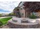 Stone patio with firepit and bench, adjacent to the house at 11877 W Yale Pl, Lakewood, CO 80228