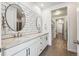 Elegant bathroom with double vanity, subway tile, and linen closet at 7870 Slate River St, Littleton, CO 80125