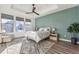 Bright and airy main bedroom with wood floors and neutral color palette at 7870 Slate River St, Littleton, CO 80125