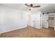 Bright bedroom showcases a closet with a sliding door, stylish herringbone floors, and neutral tones at 9272 E Mansfield Ave, Denver, CO 80237