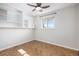Bedroom with built in shelving and window, featuring herringbone floors at 9272 E Mansfield Ave, Denver, CO 80237