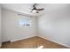 This light and airy bedroom boasts herringbone floors and a ceiling fan at 9272 E Mansfield Ave, Denver, CO 80237