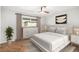 Stylized bedroom boasts herringbone floor, natural light, neutral tones, and modern furniture at 9272 E Mansfield Ave, Denver, CO 80237