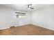 Empty bedroom featuring a herringbone floor, a ceiling fan, and a window with natural light at 9272 E Mansfield Ave, Denver, CO 80237