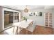 A dining room with a dining table, chairs, wood floors and sliding glass door at 9272 E Mansfield Ave, Denver, CO 80237