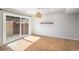 A dining room with wood floors and a sliding glass door leading to an outdoor patio at 9272 E Mansfield Ave, Denver, CO 80237