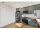 Updated kitchen with stainless steel appliances and shaker cabinets, with sunny herringbone floors at 9272 E Mansfield Ave, Denver, CO 80237