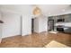 Bright kitchen with modern appliances, herringbone floor, stylish lighting and muted-green cabinets at 9272 E Mansfield Ave, Denver, CO 80237
