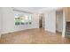 A living room features wood-look herringbone floors, large windows, and stairs at 9272 E Mansfield Ave, Denver, CO 80237