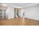 A spacious room features wood-look herringbone floors, stairs, and a sliding glass door at 9272 E Mansfield Ave, Denver, CO 80237