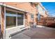 Enjoy outdoor living on this brick patio, enhanced with string lights and privacy fencing at 9272 E Mansfield Ave, Denver, CO 80237