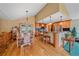 Inviting dining area with wood floors, access to the outdoor deck, and adjacent to the kitchen at 27612 Shadow Mountain Dr, Conifer, CO 80433