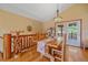 Cozy dining room features wood floors, a rustic dining table, and doors to the outdoor deck at 27612 Shadow Mountain Dr, Conifer, CO 80433