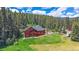 Hilltop home surrounded by lush forest; features deck for enjoying views at 27612 Shadow Mountain Dr, Conifer, CO 80433