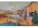 Bright kitchen features stainless appliances, wood cabinetry, and an island with granite countertops at 27612 Shadow Mountain Dr, Conifer, CO 80433
