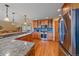 Well-equipped kitchen with stainless steel appliances, granite countertops, and hardwood floors at 27612 Shadow Mountain Dr, Conifer, CO 80433