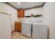 Functional laundry room with a sink, cabinetry, washer, and dryer for convenience and organization at 27612 Shadow Mountain Dr, Conifer, CO 80433