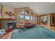 Cozy living room with fireplace, large windows, and scenic views at 27612 Shadow Mountain Dr, Conifer, CO 80433