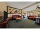 Relaxing living room area with cozy leather seating, rustic decor, and ample space for entertainment at 27612 Shadow Mountain Dr, Conifer, CO 80433