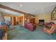 Spacious living area with comfortable seating, rustic decor, and adjacent office space for a versatile living at 27612 Shadow Mountain Dr, Conifer, CO 80433